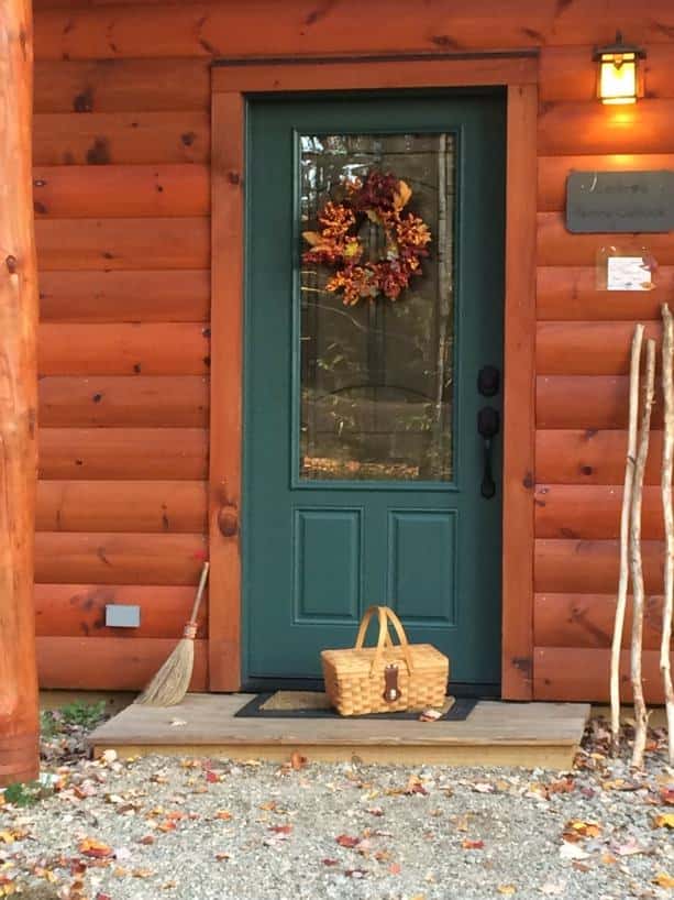 Log cabin with green painted glass door