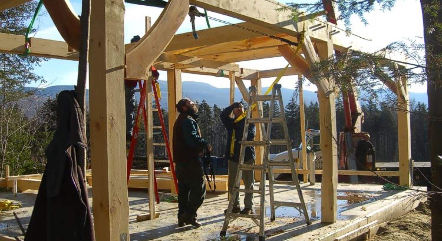 Two men constructing a cabin in the winter time