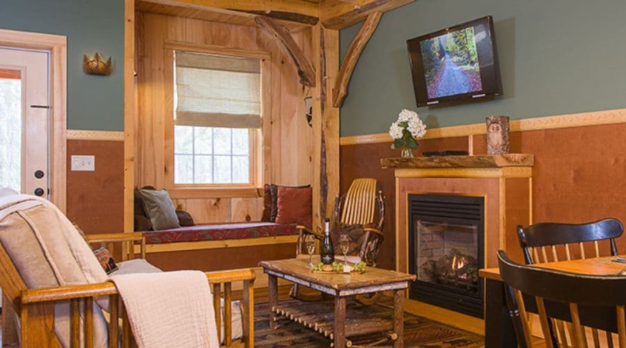 Cozy living space featuring a fireplace, wooden furniture, and a mounted TV.